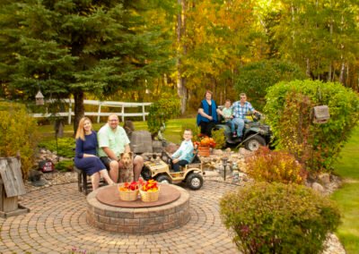 “Entire family poses together on their acreage, including grandparents, adult children, and grandchildren, captured during a multi-generational family portrait session by David Thielen Photographic Artistry”