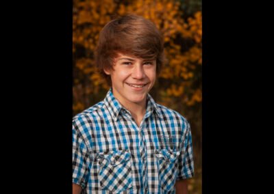 “Portrait of a young man, the son from an extended family session, captured by David Thielen Photographic Artistry”