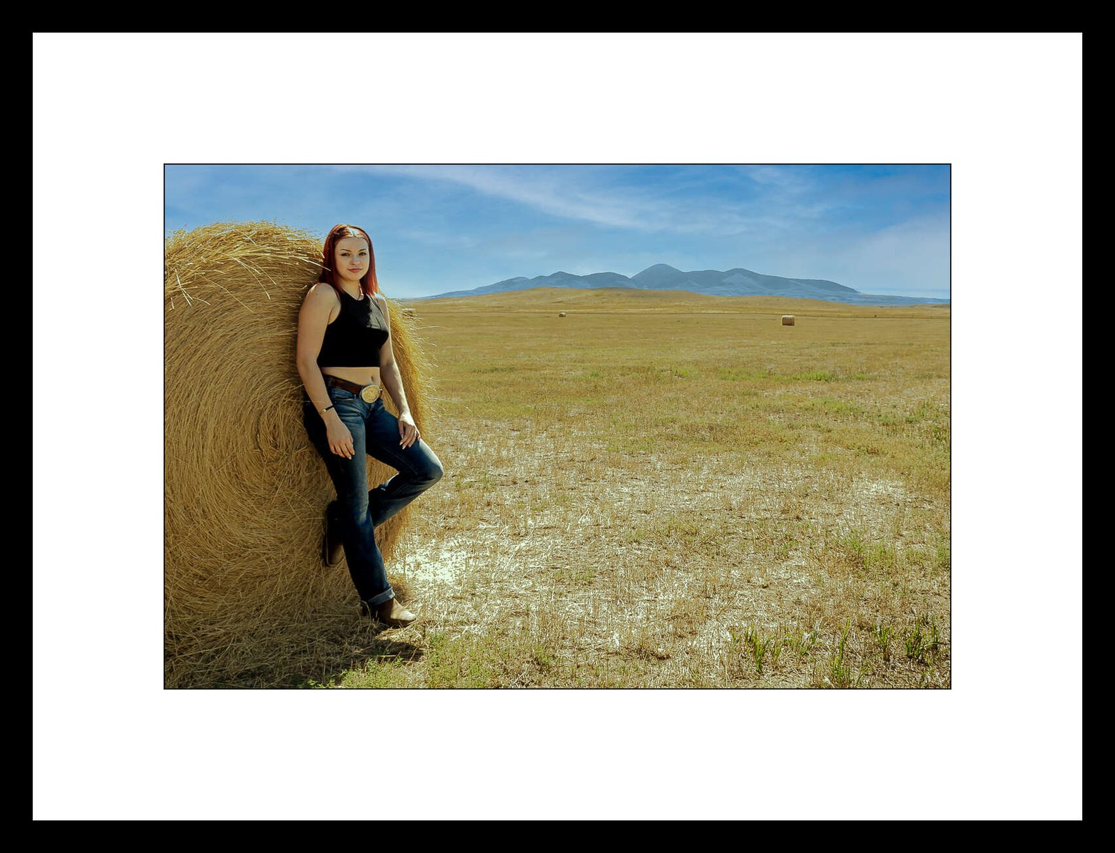 Photograph of a girl by a round bale at Writing On Stone Provincial Park, by David Thielen Photographic Artist